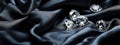 Shiny diamonds brilliants gemstones on navy blue fabric wavy background. Luxury Diamonds crystals and silk satin fabric texture