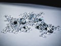 Shiny diamonds stones laying on white table Royalty Free Stock Photo