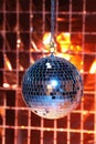Shiny disco ball against foil party under color lights Royalty Free Stock Photo