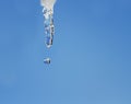 Shiny dripping icicle on blue sky background Royalty Free Stock Photo