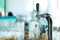 Shiny faucet for a classic draft beer in a restaurant with glasses on background Royalty Free Stock Photo