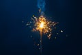 shiny fire sparkler on dark blue background Royalty Free Stock Photo
