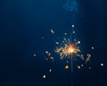 shiny fire sparkler on dark blue background with copy-space Royalty Free Stock Photo