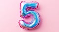 Shiny foil balloon shaped as number five on pink background, celebration concept Royalty Free Stock Photo