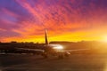 The shiny fuselage of the aircraft and its silhouette in the parking lot of the airport in the evening at a beautiful sunset with Royalty Free Stock Photo