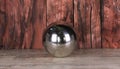 shiny geometric metallic ball on wooden