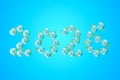 Shiny glass balls with number 2026 arranged against a blue background Royalty Free Stock Photo