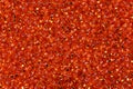 Shiny glass orange seed beads close-up background. Royalty Free Stock Photo