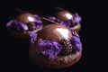 Shiny glazed chocolate and blackberry desserts with purple microwave sponge and fresh berries on black background