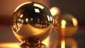 a shiny gold ball and a shiny gold sphere on a reflective surface with a reflection of light Royalty Free Stock Photo