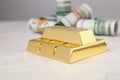 Shiny gold bars and dollar rolls Royalty Free Stock Photo