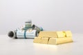 Shiny gold bars and dollar rolls on table. Space Royalty Free Stock Photo