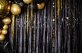 Shiny gold, black balloons. New year baubles, glossy sparkles.