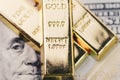 Shiny gold bullions ingot stack on america US dollar banknote mo