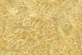 Shiny gold foil background with pattern. Yellow metallic texture with reflection