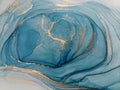 Luxury abstract fluid art painting background alcohol ink technique blue and gold. Swirls of shiny gold edges. Royalty Free Stock Photo