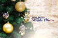 Shiny gold and silver christmas balls on white with pine tree. Yeni yiliniz kutlu olsun means happy new year