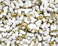 Shiny Gold and White Disposable Mugs in a Huge Pile