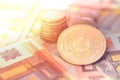 Shiny golden AXT cryptocurrency coin on blurry background with euro money Royalty Free Stock Photo