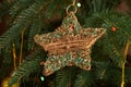 Golden bulbs and star on christmas tree close up Royalty Free Stock Photo