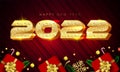 Shiny golden color style 2022 happy new year lettering, Gift boxes, gold snowflakes, baubles, stars and pine leaves around on red Royalty Free Stock Photo