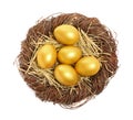 Shiny golden eggs in nest on white background, top view Royalty Free Stock Photo