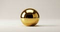 A shiny golden sphere rests on a smooth, light-colored surface. The reflective Royalty Free Stock Photo