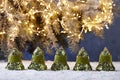 Christmas bells on snowy table on tree lights background Royalty Free Stock Photo