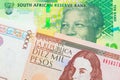 A shiny, green 10 rand bill from South Africa paired with a brown ten thousand bank note from Colombia.