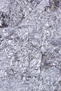 Shiny heavily wrinkled metal silver gray foil vertical texture background Royalty Free Stock Photo