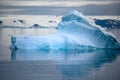 Shiny iceberg floating in calm water on foggy morning in Antarctica. Typical misty day in Antarctica. Royalty Free Stock Photo