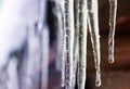 Shiny icicles hang in a Sunny spring day Royalty Free Stock Photo