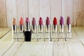 Shiny lipstick and one black Royalty Free Stock Photo