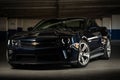 Shiny luxury Chevrolet Camaro in a dark parking garage