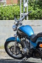 Shiny metal blue motorbike parking on the street - azure blue motorcycle Royalty Free Stock Photo