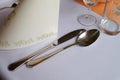 Metal cutlery lie on a white tablecloth Royalty Free Stock Photo