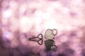Shiny metal heart lock and key in pink light and bokeh background, valentine theme, romantic and dreamy look Royalty Free Stock Photo