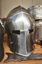 Shiny metal helmets of medieval knights with traditional weapons at a middle age theme festival Royalty Free Stock Photo