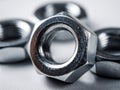 Shiny metal hex nuts with detailed threading arranged on a smooth surface showcasing mechanical hardware components for industrial Royalty Free Stock Photo
