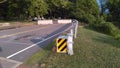 Metal protective barrier with reflective black and yellow marking sign at newly constructed small bridge 2-C-504. NJ, USA. Ãâ.