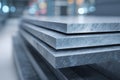 Metal sheets stacked neatly in a construction warehouse setting during daylight hours Royalty Free Stock Photo