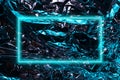 Shiny metal surface of aluminum rumpled foil with blue highlights, abstract background with neon frame