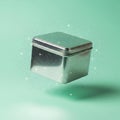 Shiny Metal Tin Box on Green Background Royalty Free Stock Photo