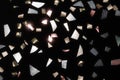 shiny metallic confetti on a black background