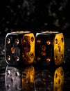 Shiny metallic dice on reflective surface Royalty Free Stock Photo