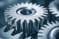 Shiny metallic gears interlocking together representing industrial mechanics and precision engineering in a close-up view with Royalty Free Stock Photo