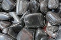 metallic gray tumbled hematite gemstone as mineral rock