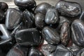 metallic gray tumbled hematite gemstone as mineral rock