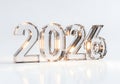 Shiny metallic numbers representing the year 2026 illuminated with warm light Royalty Free Stock Photo
