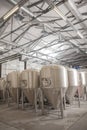 Shiny microbrewery beer tanks at beer factory Royalty Free Stock Photo